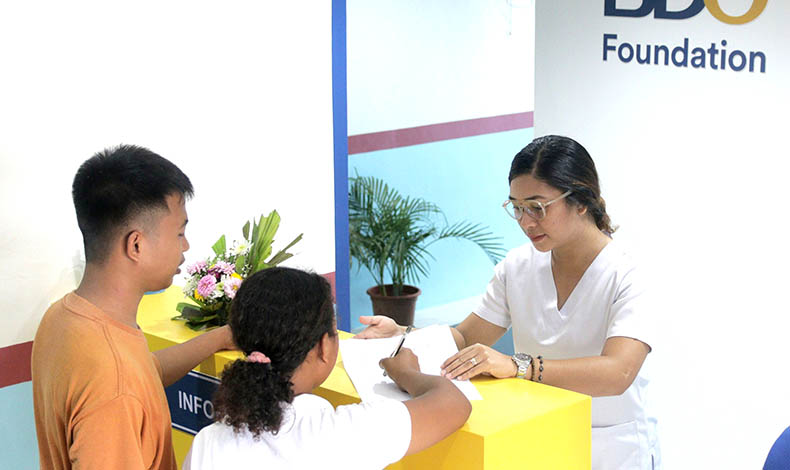 Nurse helping people fill up forms